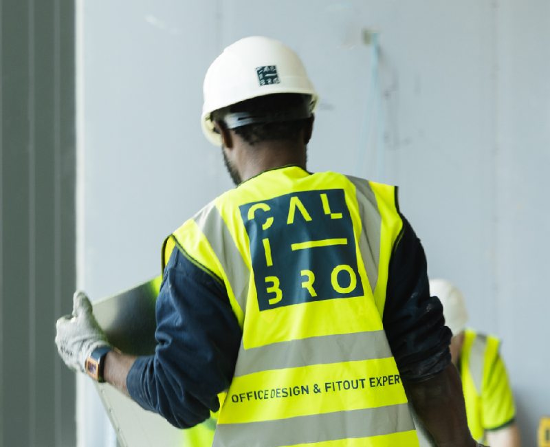 Builder onsite installing recessed flooring in an office project