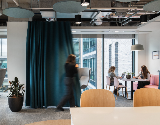 A casual meeting space in an office, with curtain for zoning
