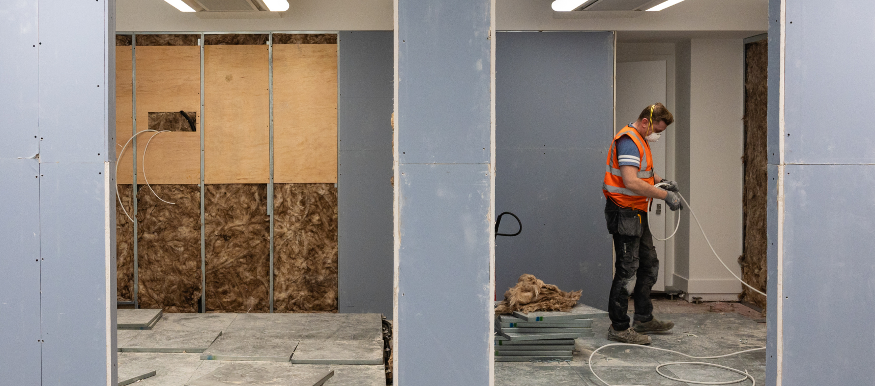Electrician completing wiring on a commercial office construction site