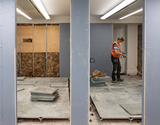 Electrician completing wiring on a commercial office construction site