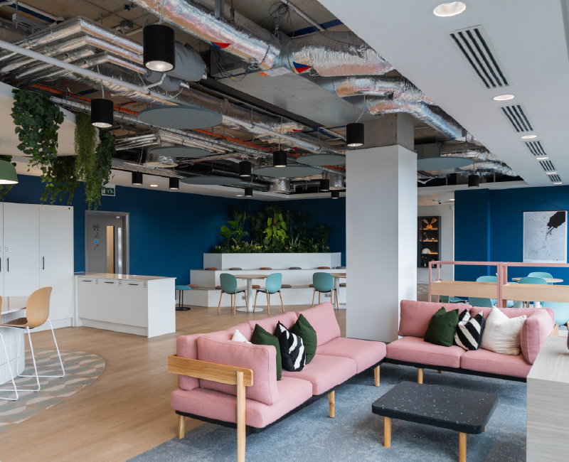 A breakout space with cosy lounge and exposed ceiling detail