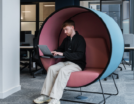 A one-person enclosed pod seat with table