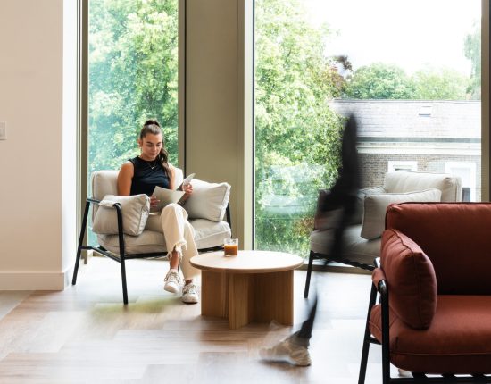 employee reading in breakout space in office